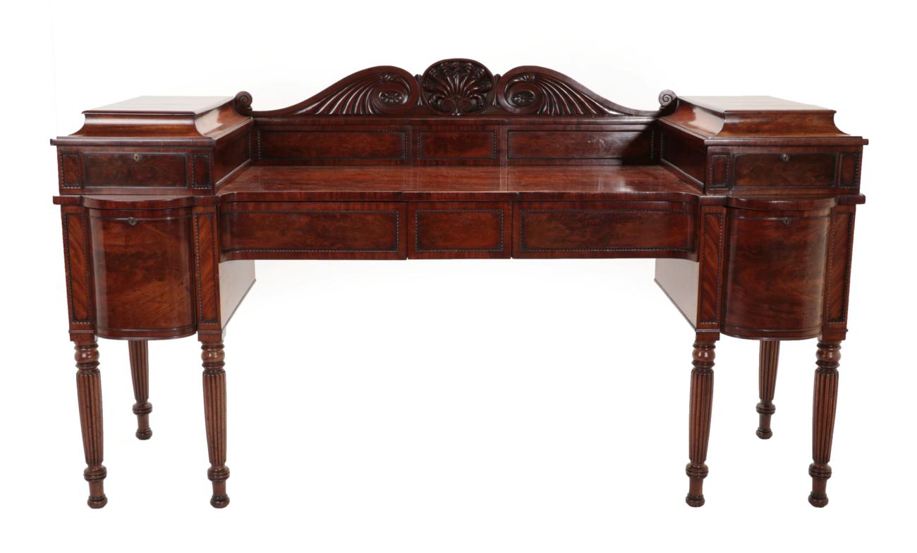 Lot 695 - A Regency Mahogany Sideboard, in the manner of Gillows, early 19th century, with scrolled...