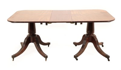 Lot 717 - A George III Mahogany Twin-Pillar Dining Table, late 18th century, with one additional leaf and...
