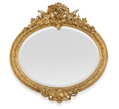 Lot 731 - A Rare and Impressive Carved Giltwood and Gesso Overmantel Mirror, circa 1860, of oval form...