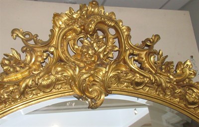 Lot 731 - A Rare and Impressive Carved Giltwood and Gesso Overmantel Mirror, circa 1860, of oval form...