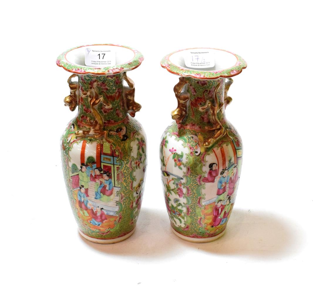 Lot 17 - A near pair of Canton famille rose baluster vases