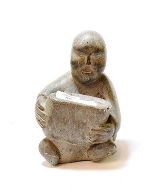 Lot 39 - An Inuit grey soapstone figure of a seated man, 20cm high, numbered 8-08059