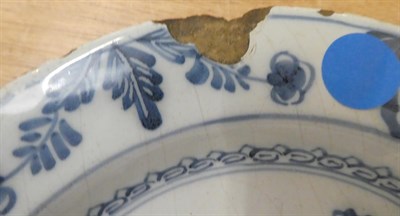 Lot 41 - An English Delft plate, circa 1750, painted in blue with a chinoiserie figure in a fenced...