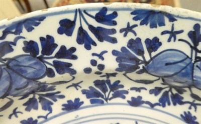 Lot 41 - An English Delft plate, circa 1750, painted in blue with a chinoiserie figure in a fenced...