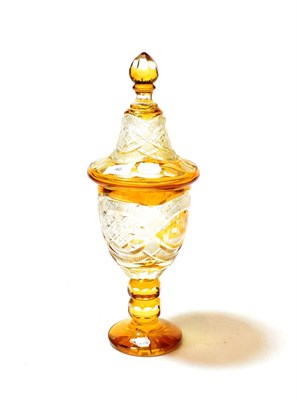 Lot 46 - A Bohemian amber overlay clear glass vase and cover, 19th century, with cut decoration, 44cm high