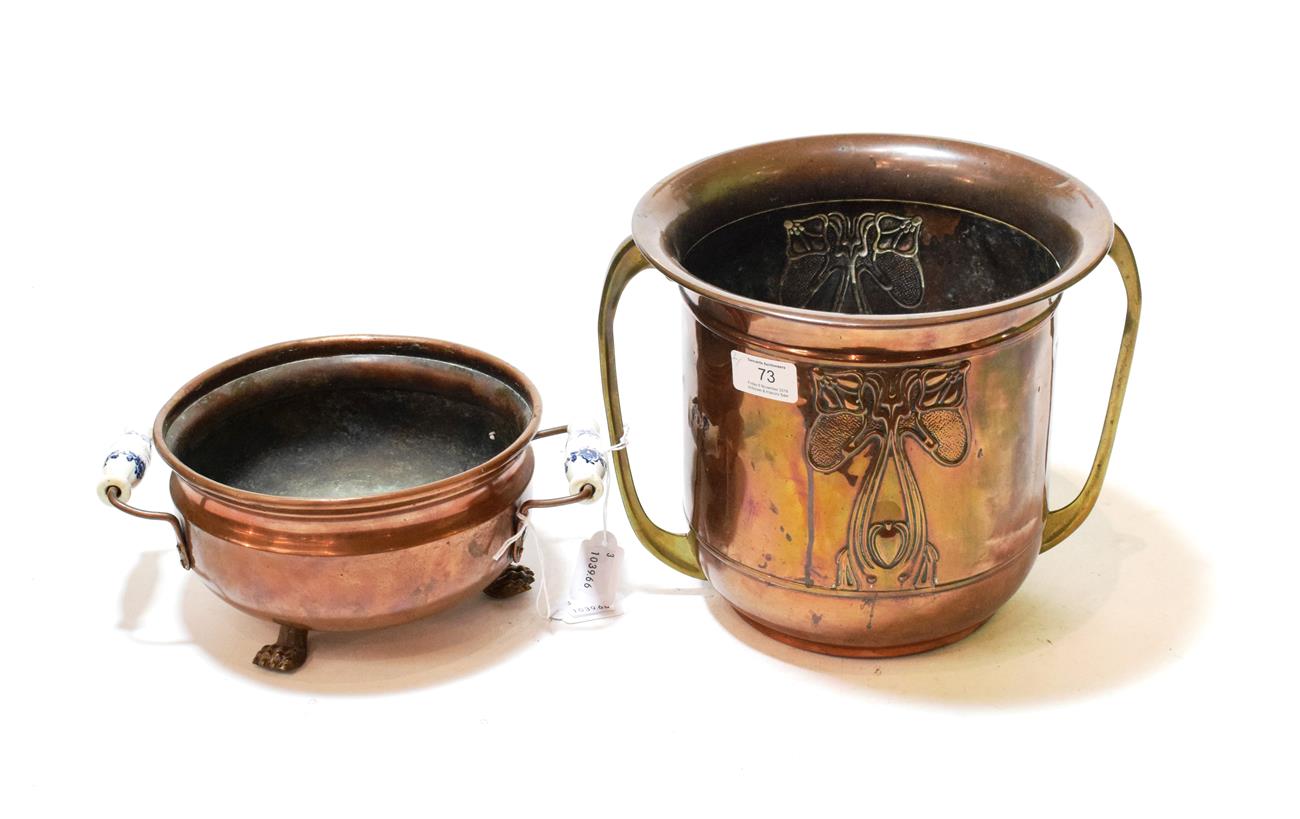 Lot 73 - An Art Nouveau copper planter with brass twin-handles; and a copper planter, on lion pad feet...