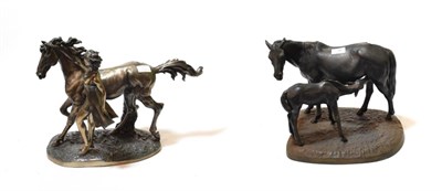 Lot 74 - A 1970's cast metal group of a mare and foal; together with a composition model of a horse...