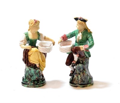 Lot 113 - A pair of late 19th century Minton Majolica figural salts, modelled as an 18th century gallant...