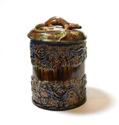 Lot 130 - A Majolica jar and cover, with applied lizard decoration, bearing an impressed mark depicting a...