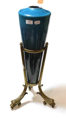 Lot 151 - An unusual tapering blue glazed Doulton vase, on a brass stand with three dolphin-form feet (a.f.)