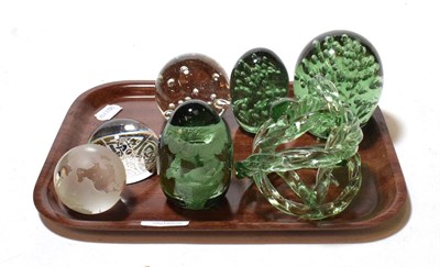 Lot 164 - Three Victorian Sunderland dump green glass paperweights, three later paperweights and a green knot