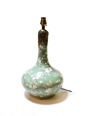 Lot 181 - A Chinese porcelain bottle vase with a celadon glaze decorated with flowers, converted to a...