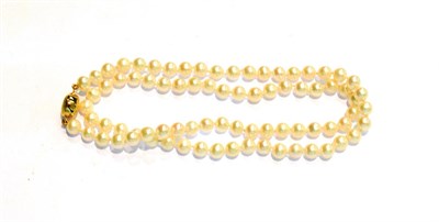 Lot 197 - A single row of cultured pearls knotted to a clasp stamped '375', length 50cm