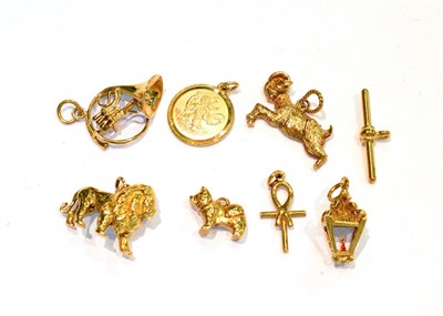 Lot 233 - Six 9 carat gold charms including a lion, a dog, a goat, a cross etc; a T-bar stamped '375'; and an