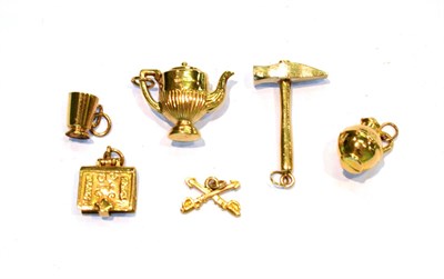 Lot 240 - Four 9 carat gold charms including a hammer, a mug, a teapot and a bible; a kettle charm...