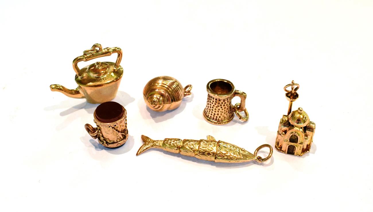 Lot 252 - Three 9 carat gold charms including an articulated fish, a tankard and a kettle; a hardstone...