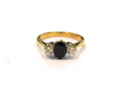 Lot 259 - A sapphire and diamond three stone ring, stamped '750', finger size N