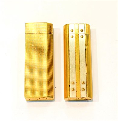 Lot 289 - Two Cartier roller lighters numbered 378655 and 82849I