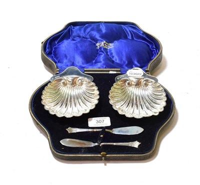 Lot 307 - A cased pair of George V silver butter-shells and knives, by David Landsborough Fullerton,...