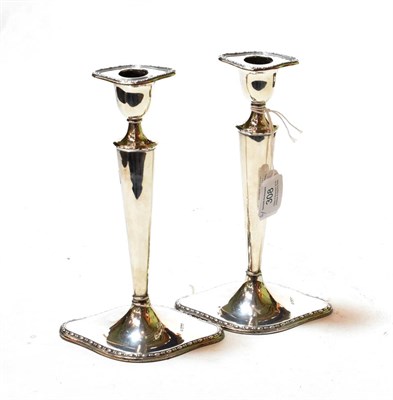 Lot 308 - A pair of Edward VII silver candlesticks, by William Hutton and Sons, Sheffield, 1907, each on...