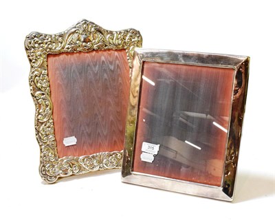 Lot 315 - Two silver plate photograph frames, one plain oblong, the other shaped oblong, stamped with foliage