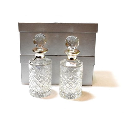 Lot 318 - Two Elizabeth II silver-mounted cut-glass decanters, by Broadway and Co., Birmingham, one 1974...