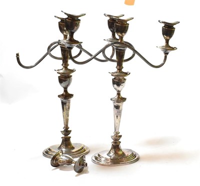 Lot 333 - A pair of George VI silver three-light candelabra, by W. Bros, Sheffield, 1951, each on stepped...