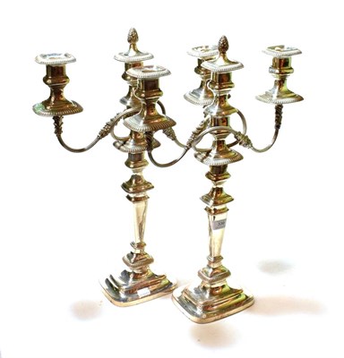 Lot 339 - A pair of Sheffield plate three-light candelabra, 19th century, each on square base and with...