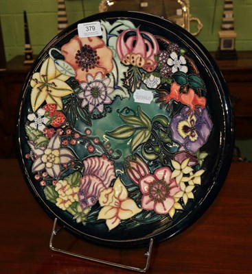 Lot 379 - A modern Moorcroft pottery charger, Carousel pattern, designed by Rachel Bishop, No. 695