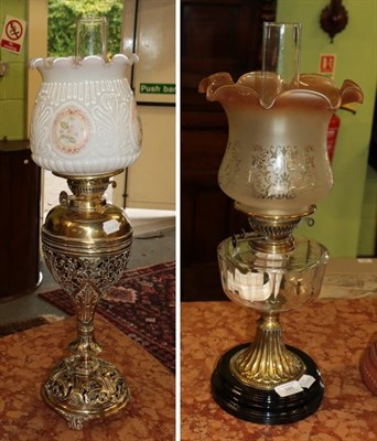 Lot 385 - A Victorian pierced brass oil lamp with painted opaque shade; together with a further Victorian oil