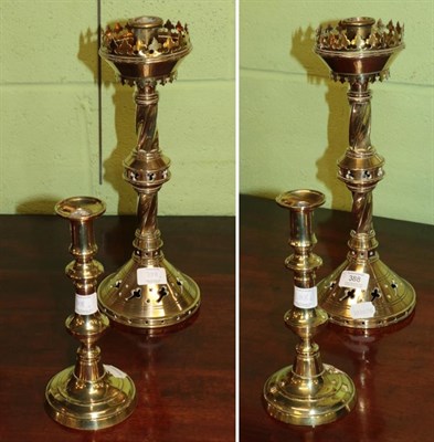 Lot 388 - A pair of Gothic candlesticks; together with a pair of brass candlesticks (4)