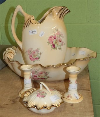 Lot 1148 - An early 20th century cream and gilt toilet set, printed with roses, comprising of: shell...