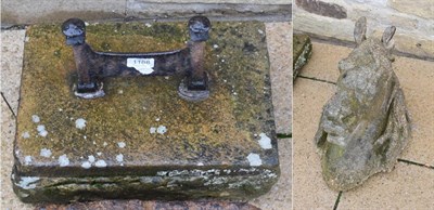 Lot 1188 - A cast iron boot scraper together with a composition horses head garden wall mount (2)