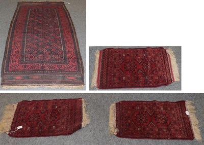 Lot 1196 - A Baluch rug, the octagonal lattice field enclosed by madder borders, 185cm by 101cm; together with