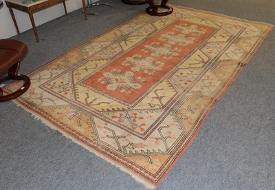 Lot 1197 - Melas Carpet, the terracotta field with five floral medallions enclosed by double borders, 302cm by