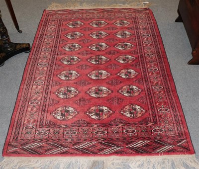 Lot 1204 - Afghan Tekke rug, the crimson field with three columns of guls enclosed by borders of octagons,...