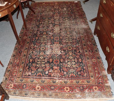 Lot 1206 - Feraghan gol henna design rug, the indigo field of stylised plants enclosed by triple borders,...