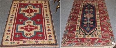 Lot 1212 - Kars rug, the raspberry field with two cruciform medallions enclosed by stellar motif borders,...