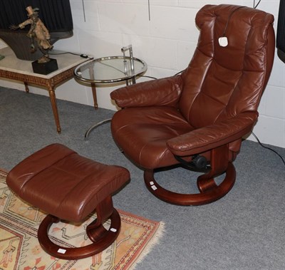 Lot 1220 - A stressless reclining leather chair with footstool
