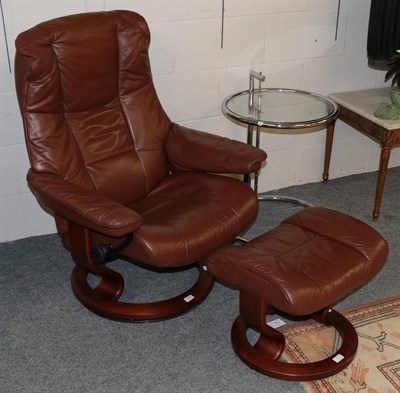 Lot 1221 - A stressless reclining leather chair with footstool