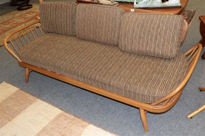 Lot 1230 - An Ercol light elm studio sofa