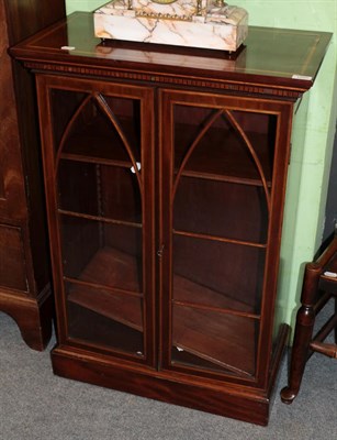 Lot 1255 - An Edwardian mahogany and satinwood banded bookcase, with arched glazed doors, 68cm wide