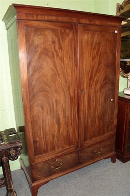 Lot 1257 - A George III mahogany double door wardrobe, the base with two drawers, 130cm wide