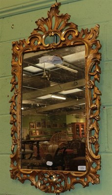 Lot 1262 - A carved giltwood wall mirror in George III style, 103cm high