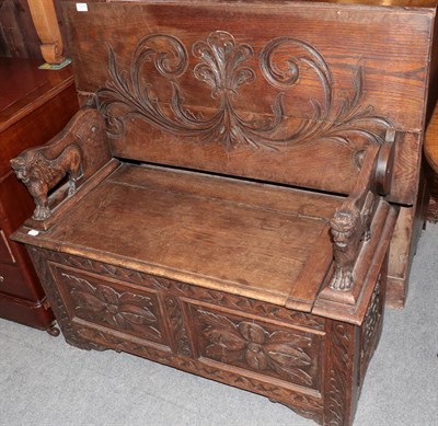 Lot 1277 - A carved oak monk's bench