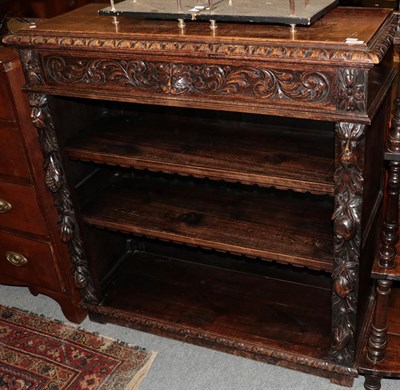 Lot 1280 - A carved oak bookcase with drawer