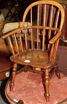 Lot 1289 - A 19th century child's Windsor spindle back armchair with elm boarded seat