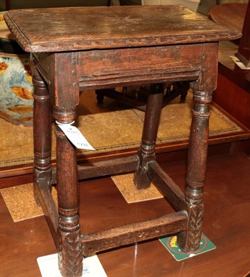Lot 1292 - An oak joint stool, circa 1680, the four peg rectangular top with carved edge above a moulded...