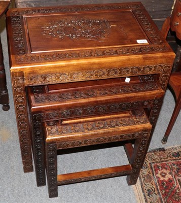 Lot 1294 - A nest of three carved hardwood occasional tables