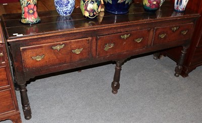 Lot 1312 - An early 18th century oak and crossbanded three drawer dresser, 181cm wide